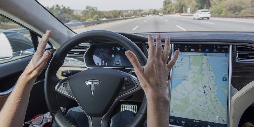 A member of the media test drives a Tesla Motors Inc., Model S car equipped with Autopilot at the Tesla Motors Inc. headquarters in Palo Alto, California, U.S., on Wednesday, Oct. 14, 2015. Tesla Motors Inc. will begin rolling out the first version of its highly anticipated “autopilot” features to owners of its all-electric Model S sedan Thursday. Autopilot is a step toward the vision of autonomous or self-driving cars, and includes features like automatic lane changing and the ability of the Model S to parallel park for you. Photographer: David Paul Morris/Bloomberg